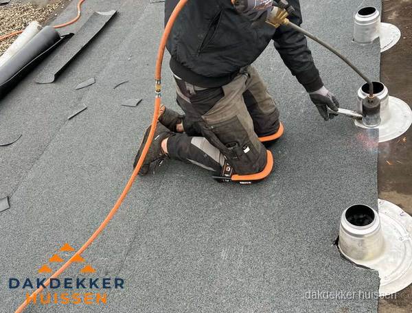 Dakdekker repareert bitumen dakleer bij dakdoorvoer in Huissen Dakdekker repareert bitumen dakleer bij dakdoorvoer in Huissen